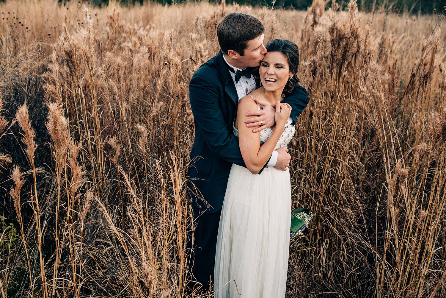 husband kissing wife on forehead