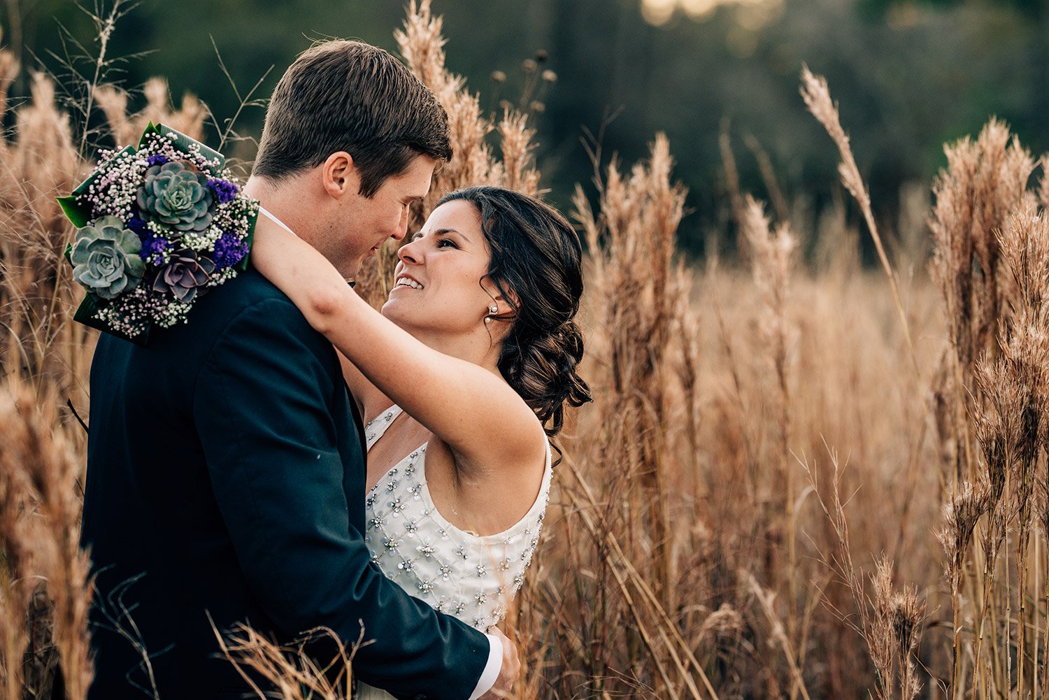 bride and groom in a field