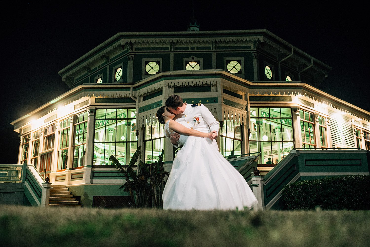 groom dips bride in front of their Galveston wedding venue, Garten Verein