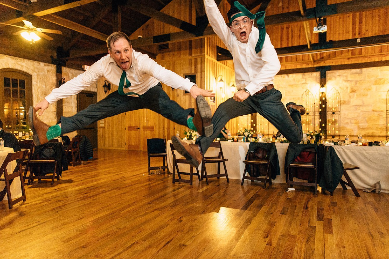 groomsmen jumping on dance floor