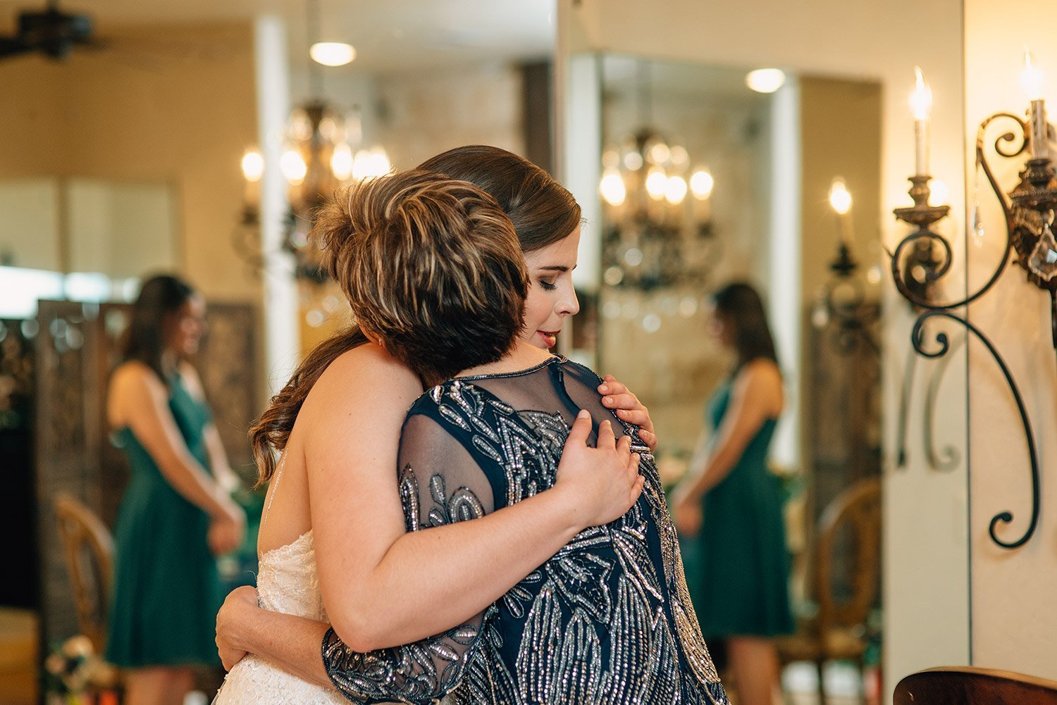 mother of the bride hugs bride in bridal room at the springs event center