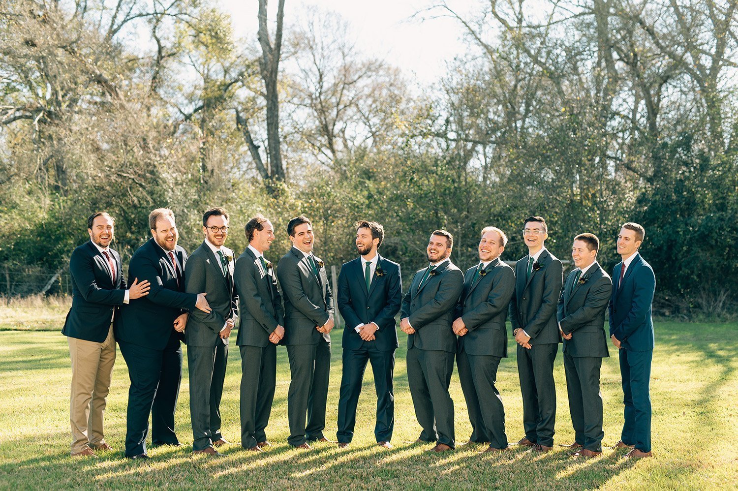 groomsmen in grey suits and green ties