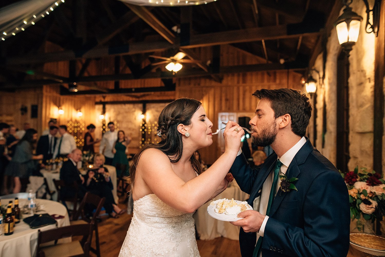bride and groom feeding one another pie