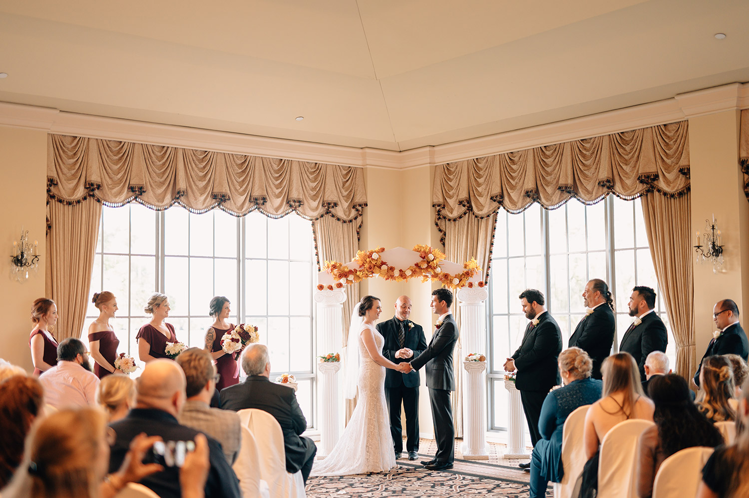 indoor wedding ceremony at sweetwater country club