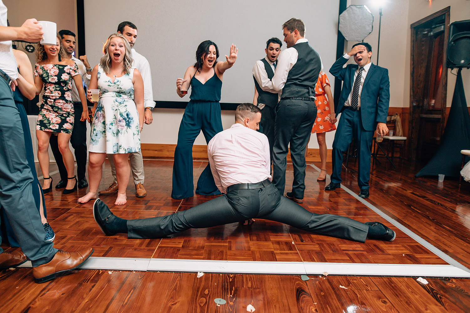 wedding guest doing splits during reception
