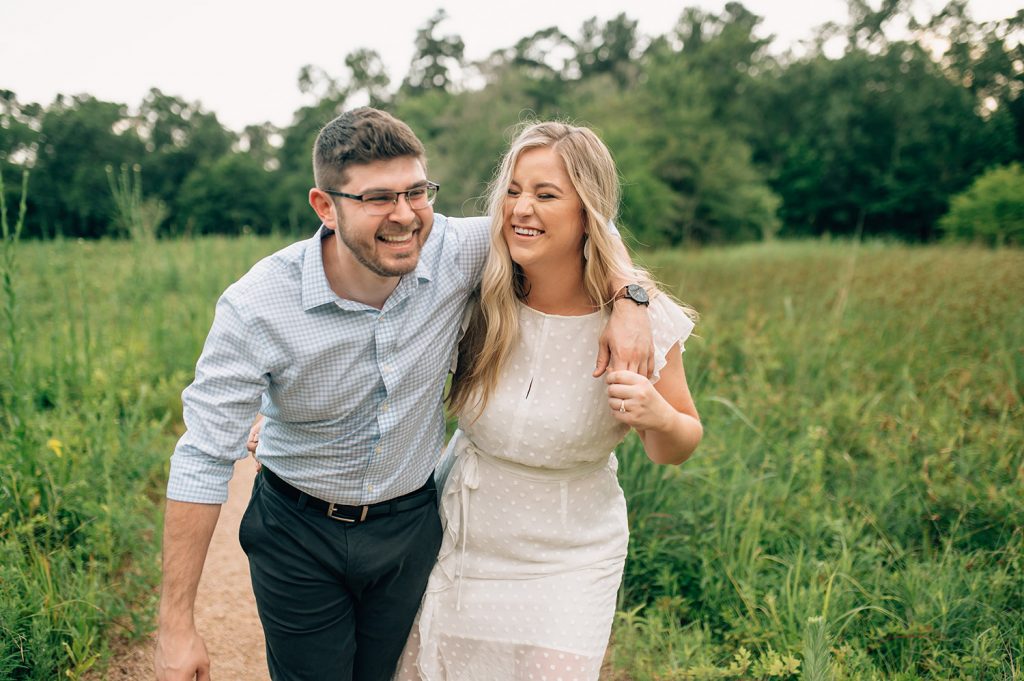 couple laughing in Houston arboretum for their Houston Engagement Photos