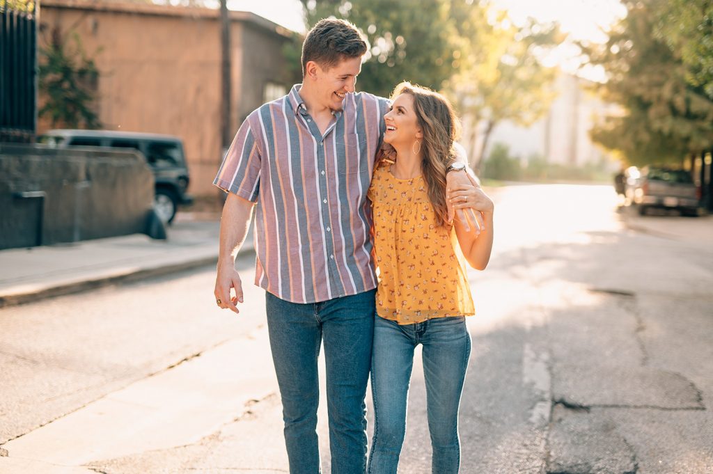 couple walking down street in Houston for engagement photos