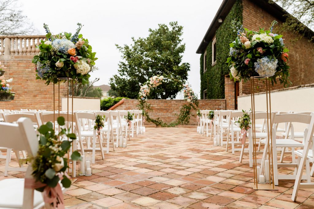 florals and chairs on patio for a wedding ceremony at the gallery houston