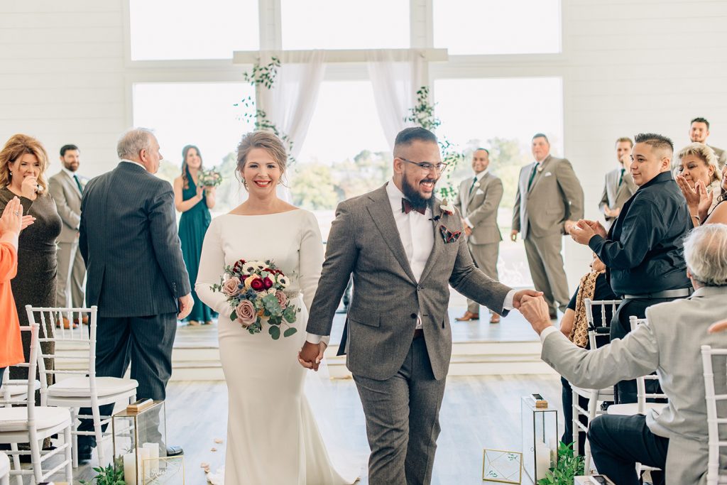 couple exiting their ceremony at their wedding at The Farmhouse